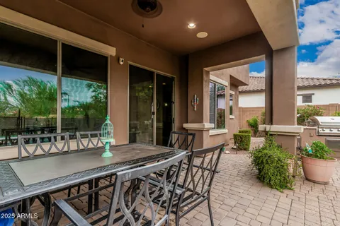 a view of swimming pool with table and chairs a fire pit