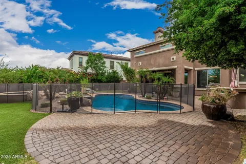 a view of a backyard with swimming pool