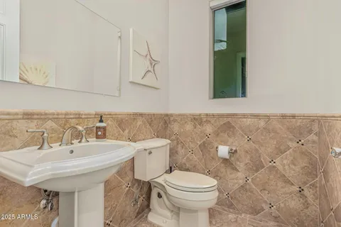 a view of swimming pool with a bench and trees in the background