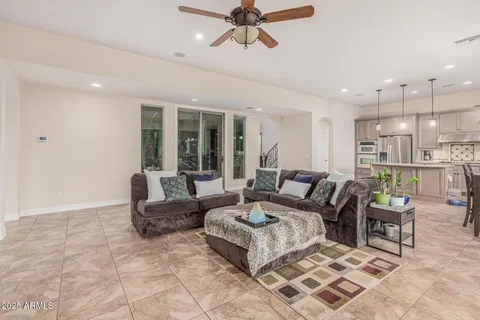 a living room with furniture and a view of kitchen