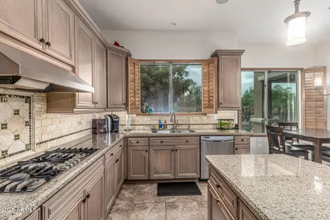 a kitchen with lots of counter top space a sink and appliances