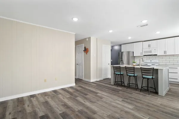 a view of kitchen with microwave and refrigerator