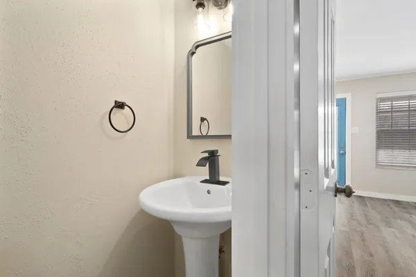 a bathroom with a sink and mirror