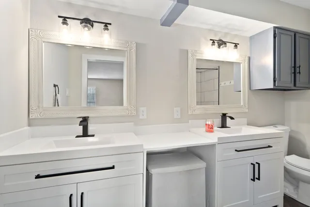 a bathroom with a sink vanity and a mirror