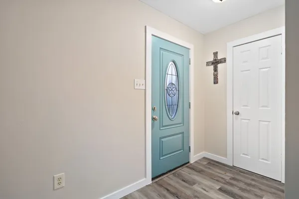 a view of a hallway with wooden floor