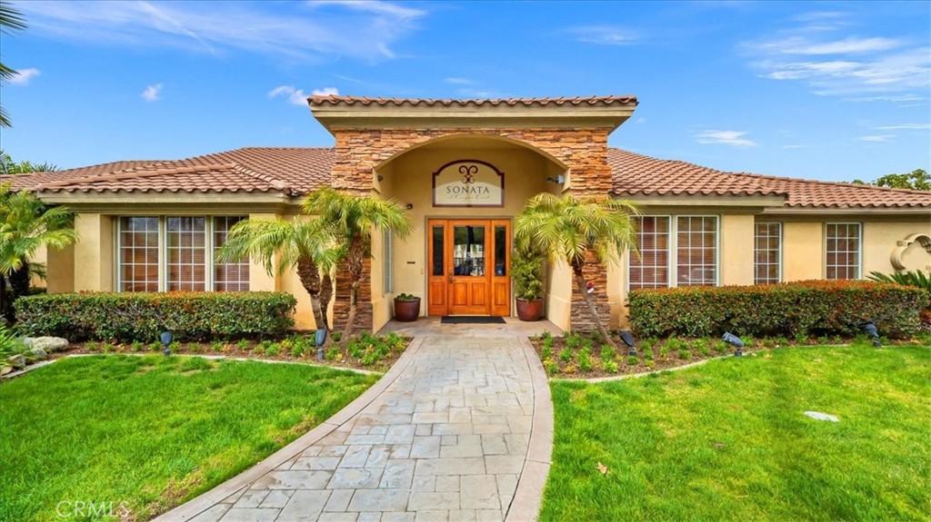 375 Central, Unit 124 Riverside, CA 92507 - Photo 19 of 31 a front view of a house with a yard