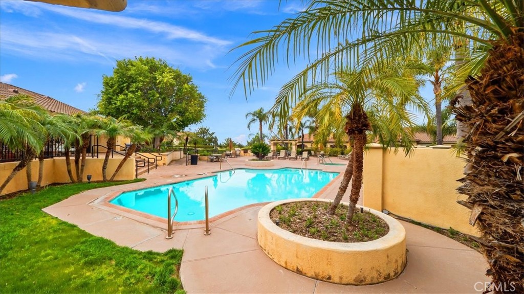375 Central, Unit 124 Riverside, CA 92507 - Photo 20 of 31 a view of a swimming pool with a patio and a yard