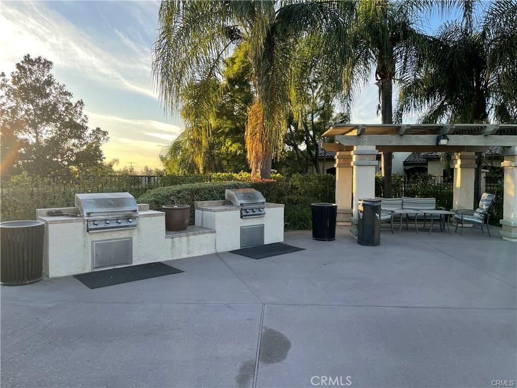 375 Central, Unit 124 Riverside, CA 92507 - Photo 22 of 31 a view of a patio with table and chairs under an umbrella