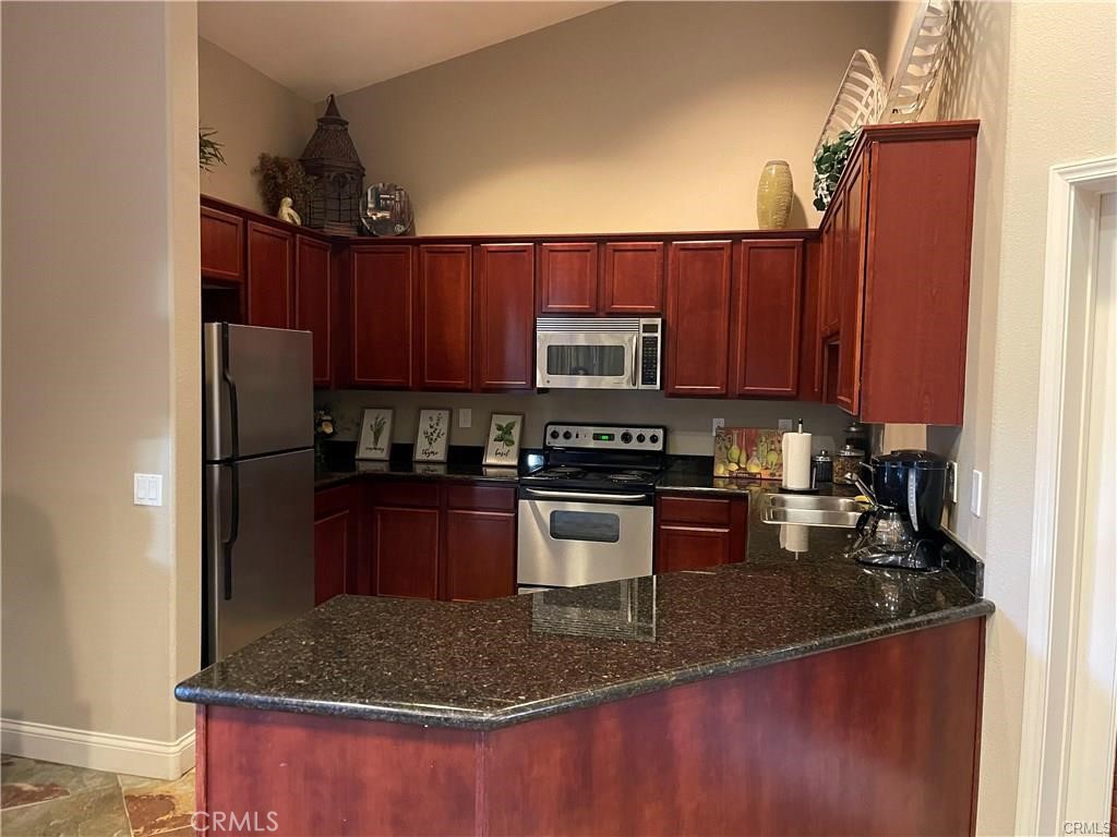 375 Central, Unit 124 Riverside, CA 92507 - Photo 27 of 31 a kitchen with stainless steel appliances granite countertop a sink stove and refrigerator
