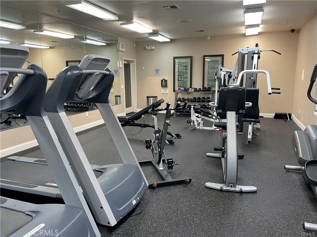 375 Central, Unit 124 Riverside, CA 92507 - Photo 30 of 31 a room with gym equipment and mirrors