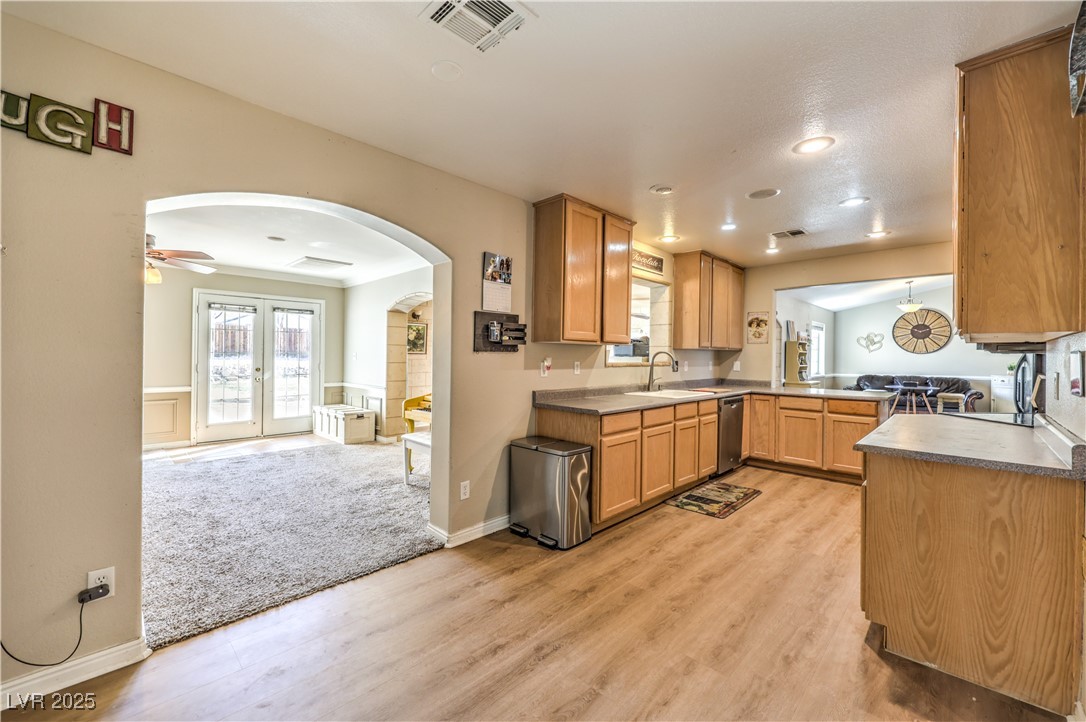 3192 North Taylor Street Logandale, NV 89021 - Photo 13 of 36 Kitchen with sink, light wood-type flooring, dishwasher, ceiling fan, and french doors
