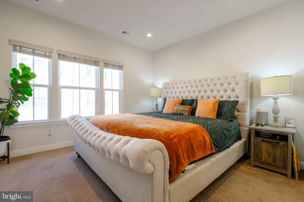 a bedroom with a bed and a large window