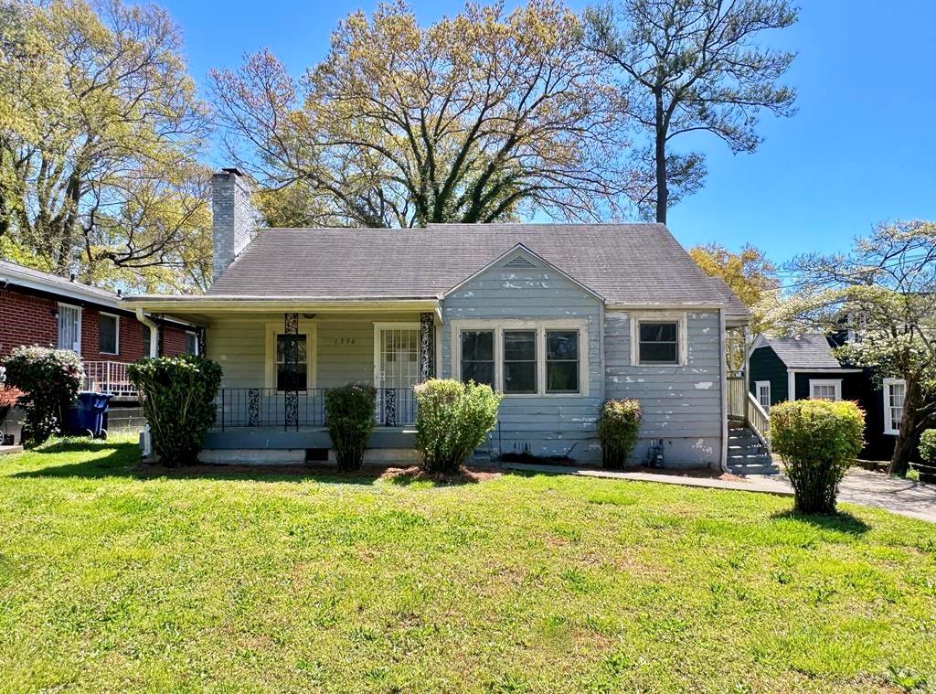 1996 Baker Road Northwest Atlanta, GA 30318 - Photo 1 of 1 a front view of a house with yard patio and fire pit