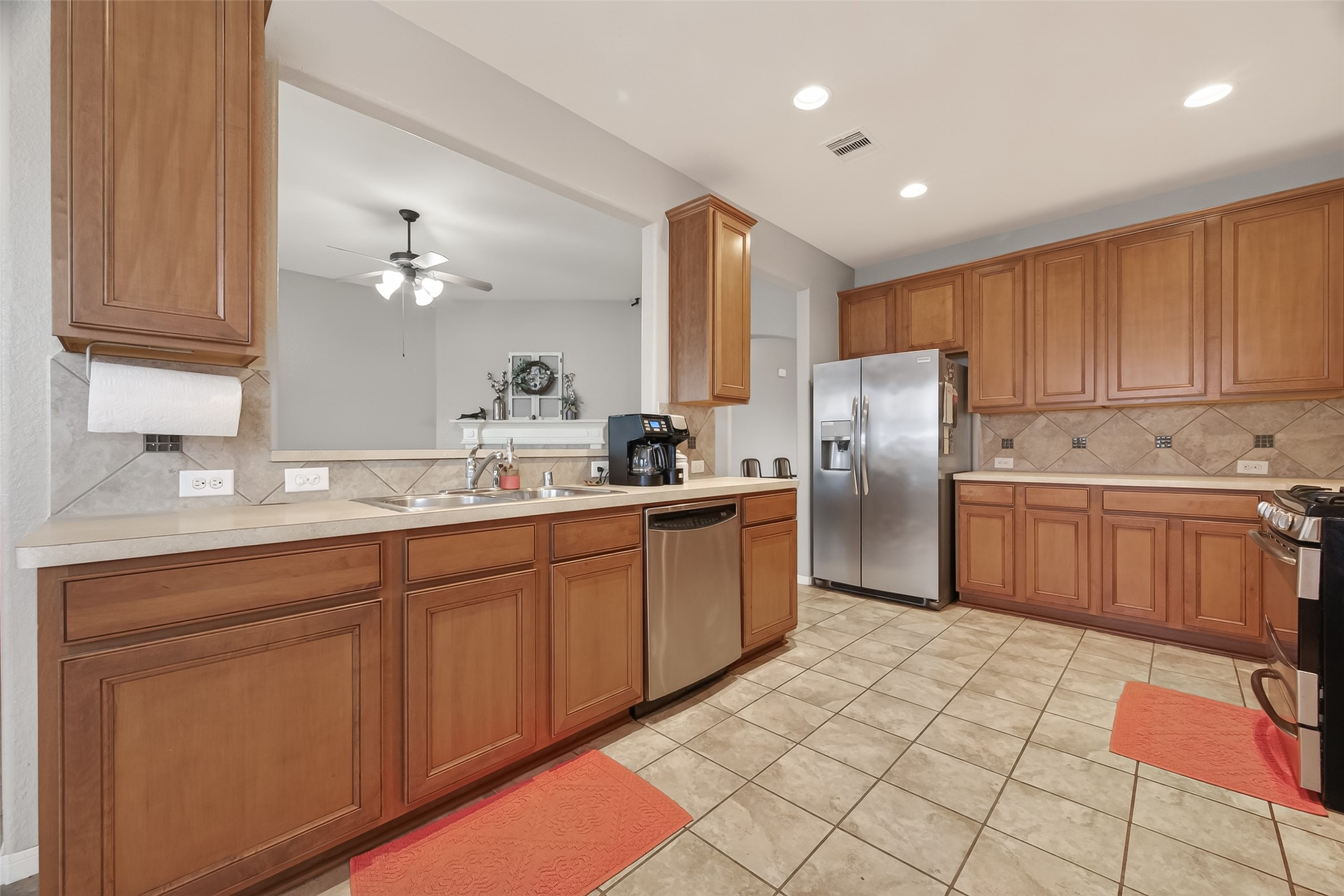 9110 Cavalier Lane Rosenberg, TX 77469 - Photo 12 of 30 a kitchen with stainless steel appliances a refrigerator sink and cabinets