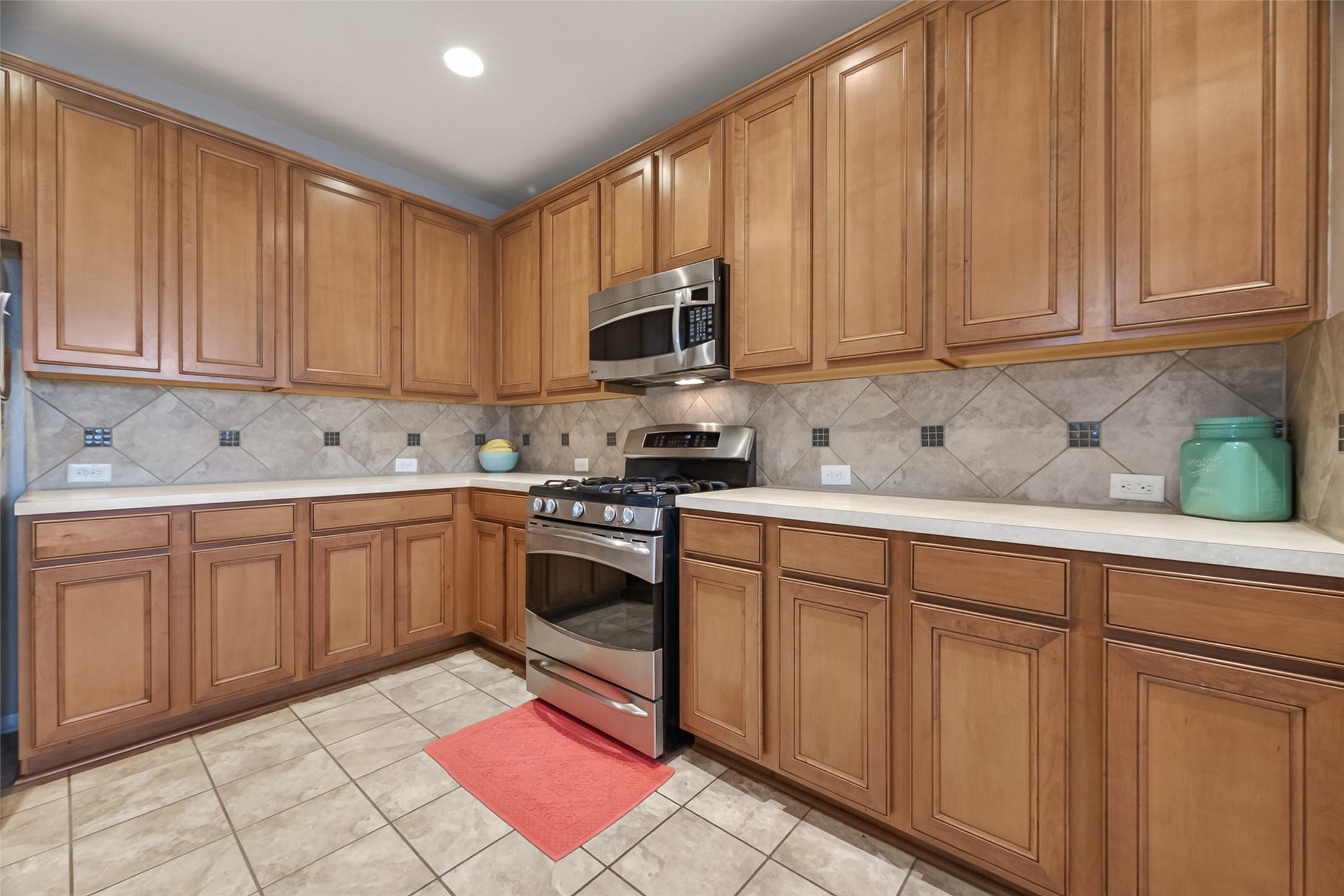 9110 Cavalier Lane Rosenberg, TX 77469 - Photo 13 of 30 a kitchen with stainless steel appliances granite countertop a refrigerator sink and cabinets