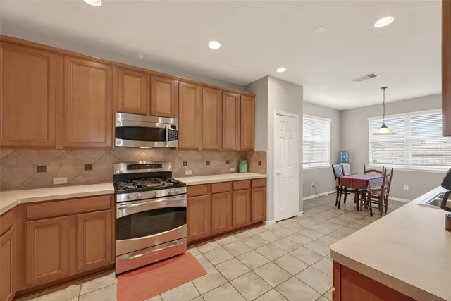 a kitchen with a sink stove and cabinets