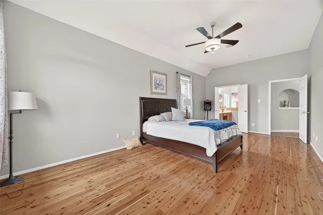 a bed room with a bed and a ceiling fan