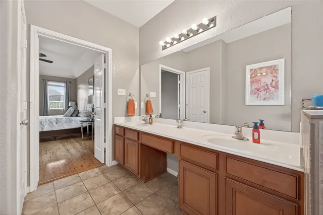 a en suite bathroom with a sink double vanity and a mirror