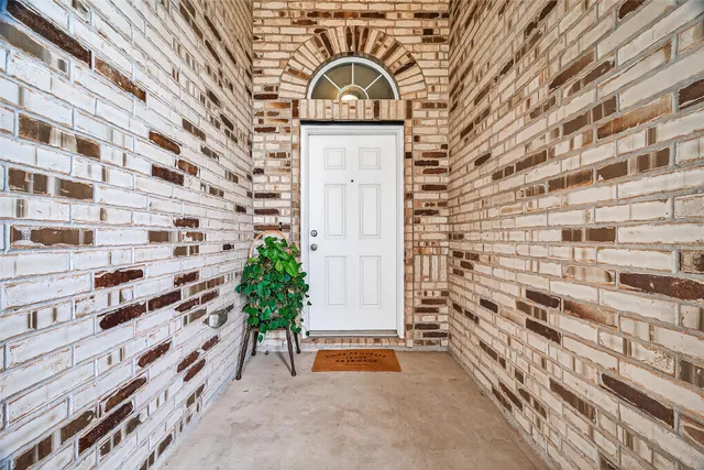 a view of a door with brick wall