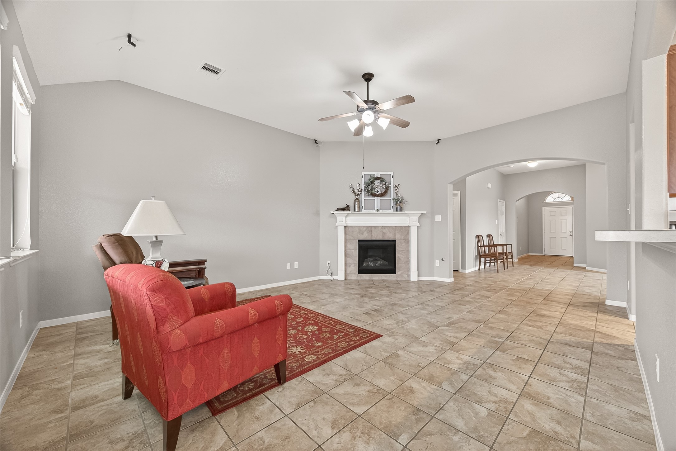 9110 Cavalier Lane Rosenberg, TX 77469 - Photo 8 of 30 a living room with furniture a fireplace and a chandelier