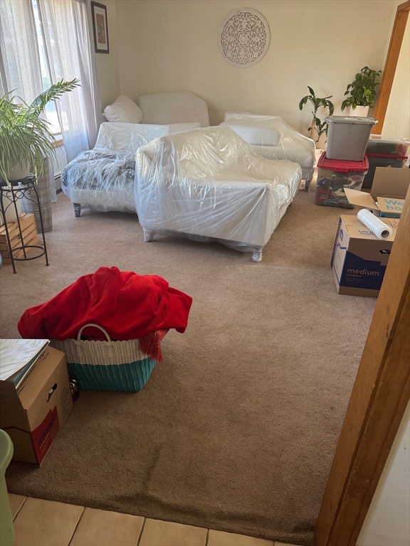 99 Garfield Avenue, Unit A Woburn, MA 01801 - Photo 2 of 3 a bedroom with bed and a couch