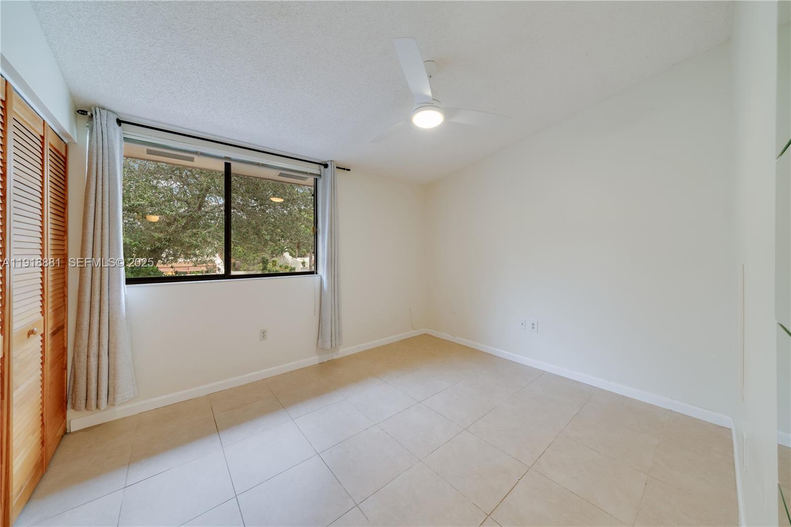 7827 Southwest 106th Circle, Unit 7827 Miami, FL 33173 - Photo 18 of 23 an empty room with windows