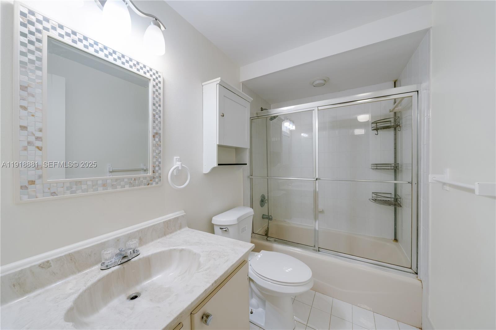 7827 Southwest 106th Circle, Unit 7827 Miami, FL 33173 - Photo 19 of 23 a bathroom with a sink a toilet and shower