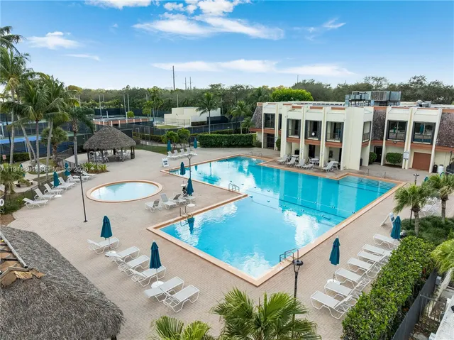 swimming pool view with a seating space