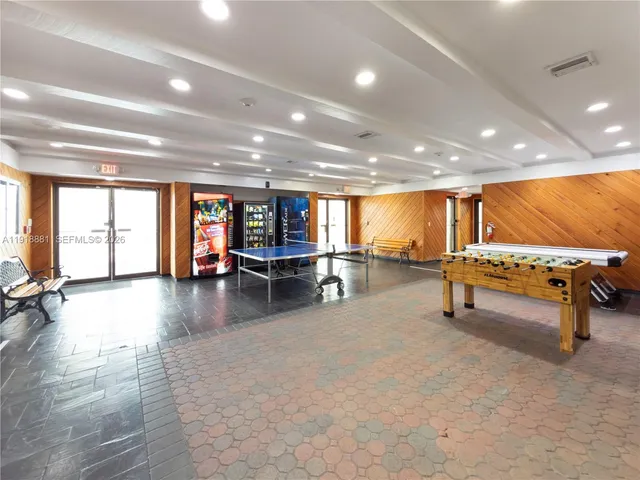 a view of a room with gym equipment and floor to ceiling window