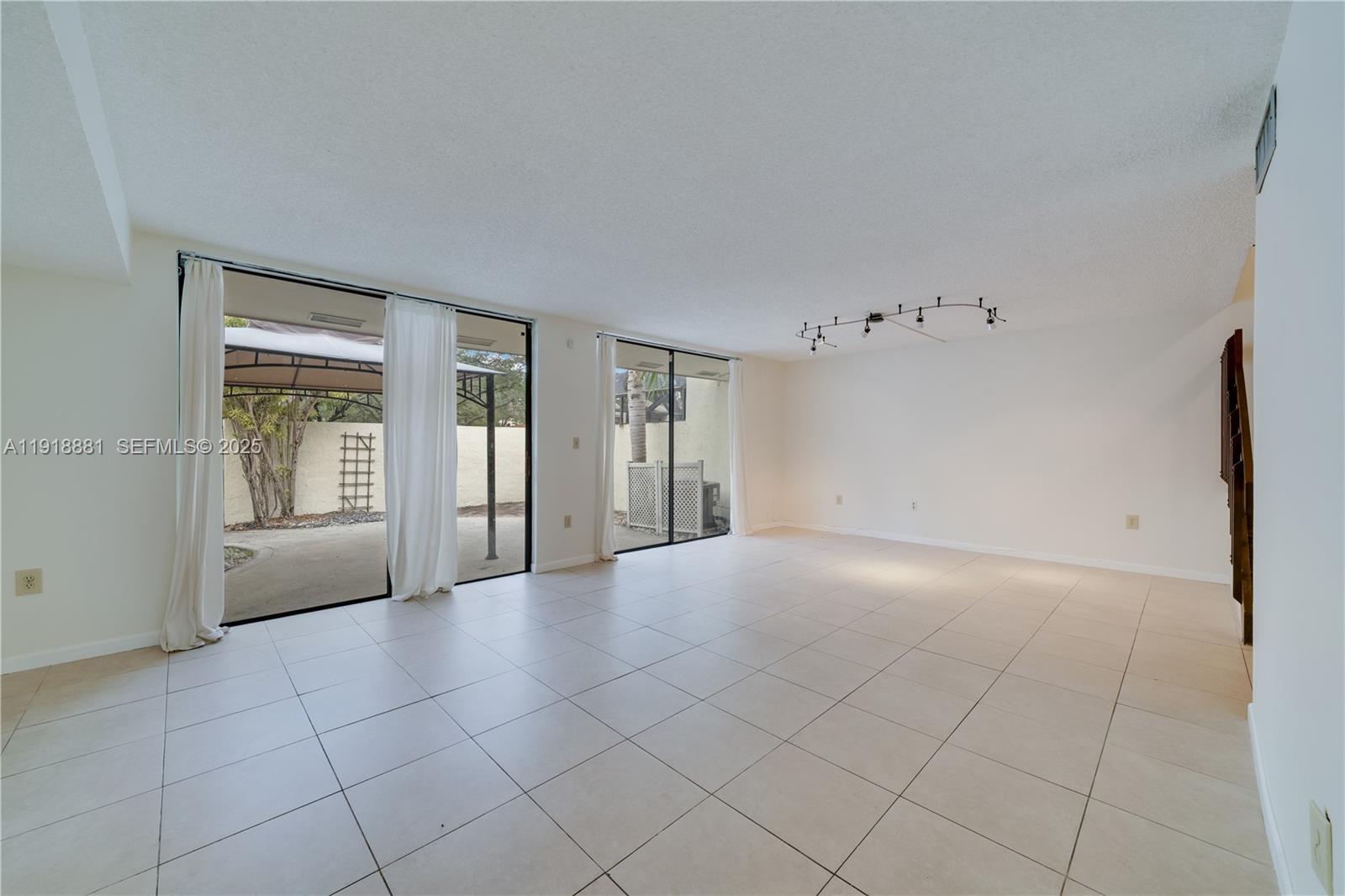 7827 Southwest 106th Circle, Unit 7827 Miami, FL 33173 - Photo 5 of 23 a view of an empty room with a window