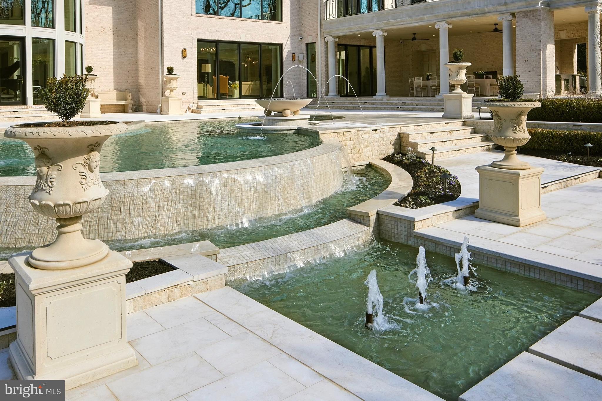 6431 Georgetown Pike McLean, VA 22101 - Photo 4 of 9 a view of a patio with table and chairs potted plants and a fountain