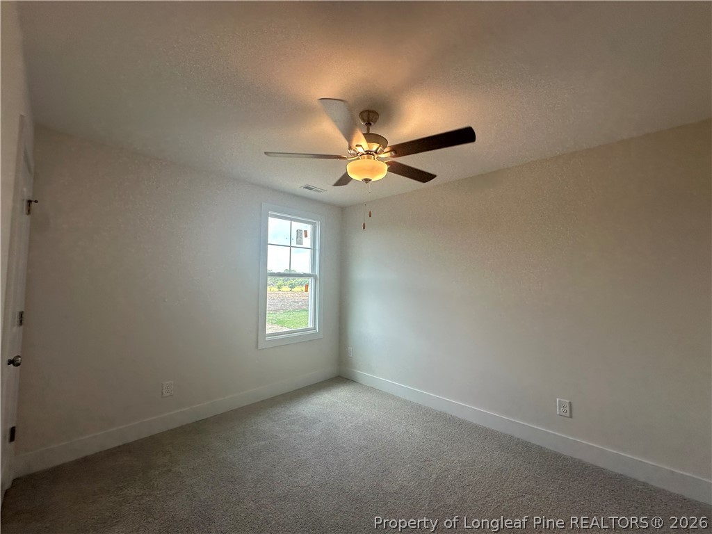 8383 Shannon Road Shannon, NC 28386 - Photo 13 of 17 an empty room with a window and a fan