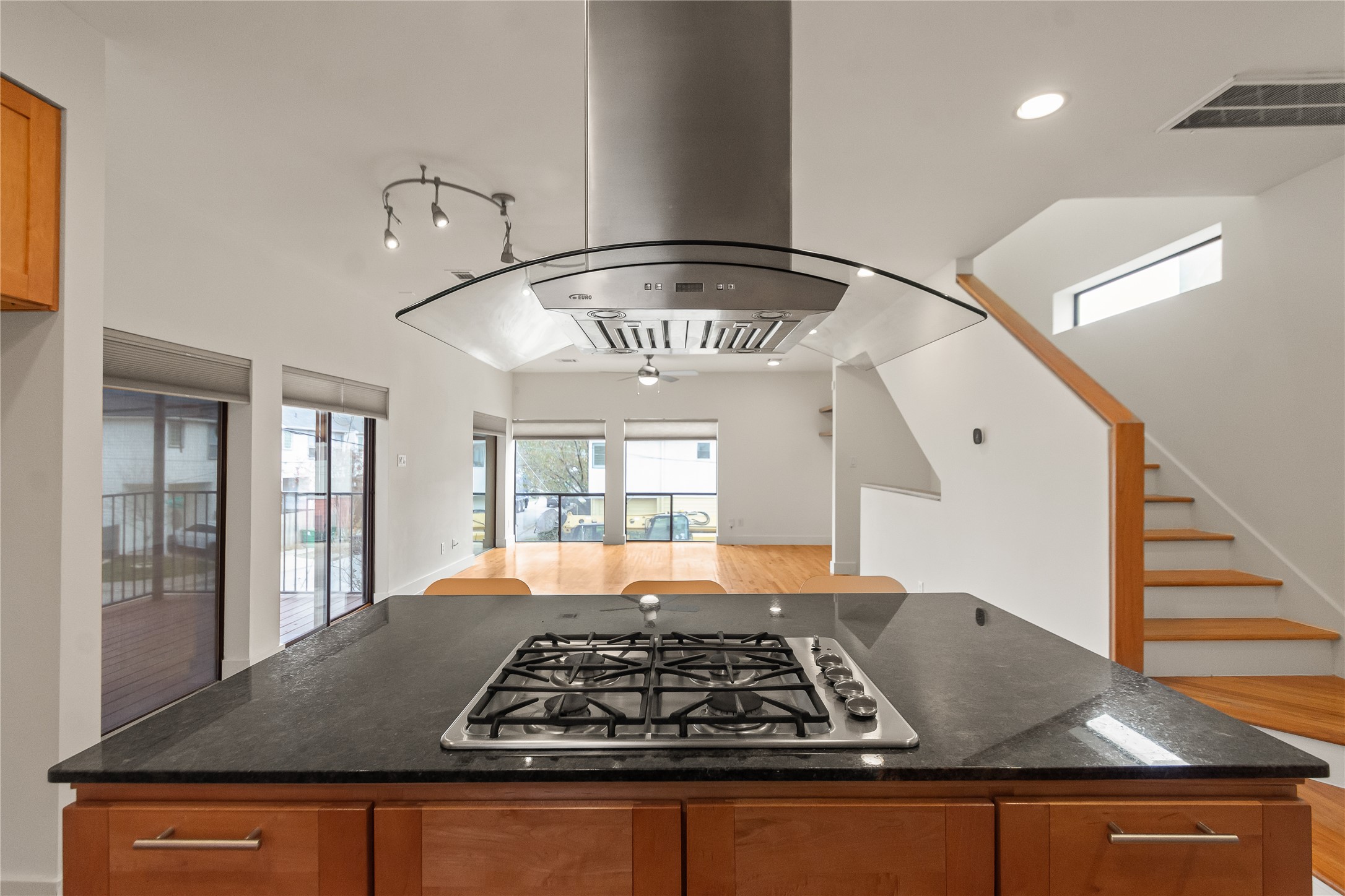 4501 Eigel Street, Unit A Houston, TX 77007 - Photo 12 of 38 Open-concept kitchen overlooking the second-floor living and dining areas, anchored by a central island with gas range—perfect for cooking, entertaining, and staying connected to the heart of the home.