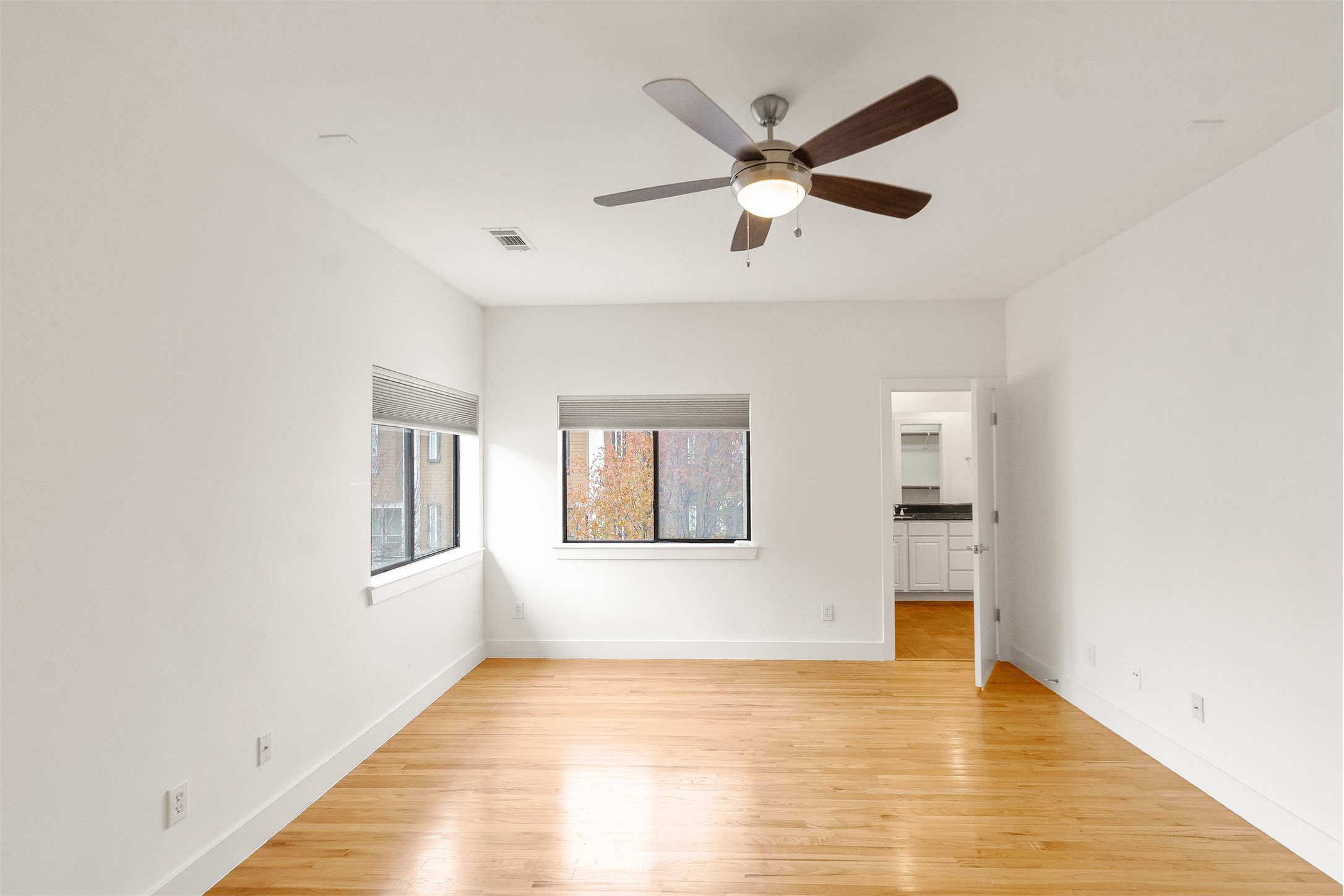 4501 Eigel Street, Unit A Houston, TX 77007 - Photo 17 of 38 Spacious primary bedroom overlooking the neighborhood with its ensuite bathroom on the right.