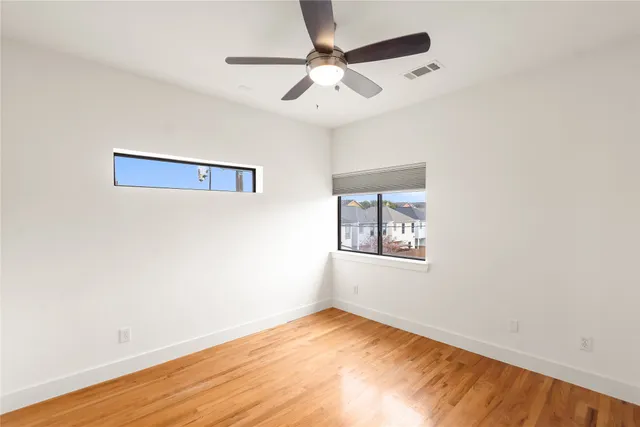 a bathroom with a granite countertop toilet and sink
