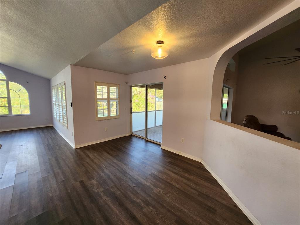 23104 Rountree Avenue Port Charlotte, FL 33980 - Photo 12 of 41 an empty room with wooden floor and windows