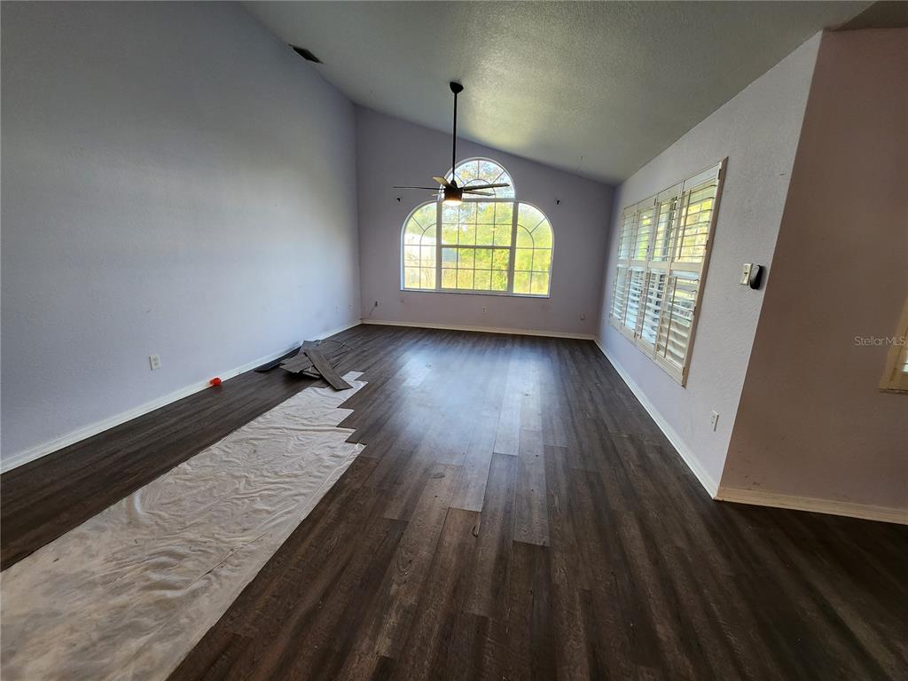 23104 Rountree Avenue Port Charlotte, FL 33980 - Photo 13 of 41 wooden floor in an empty room with a window
