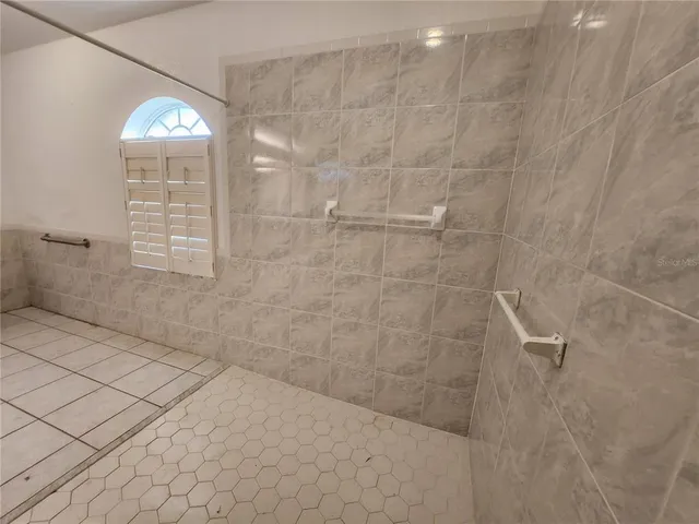a bathroom with a light fixture and a shower
