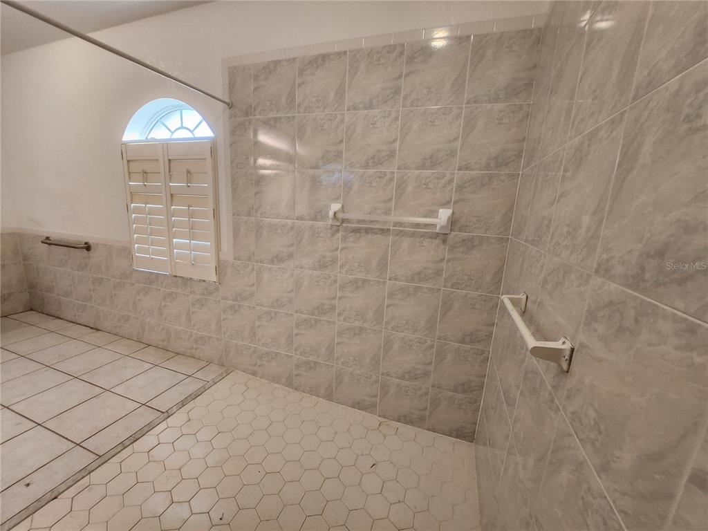 23104 Rountree Avenue Port Charlotte, FL 33980 - Photo 20 of 41 a bathroom with a light fixture and a shower