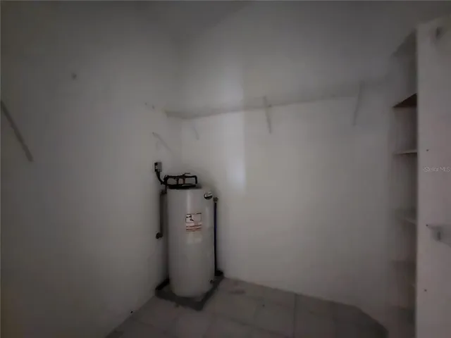 a view of a storage & utility room with a door