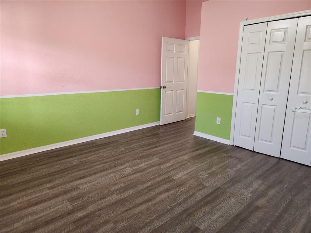23104 Rountree Avenue Port Charlotte, FL 33980 - Photo 25 of 41 a view of a room with wooden floor and white walls