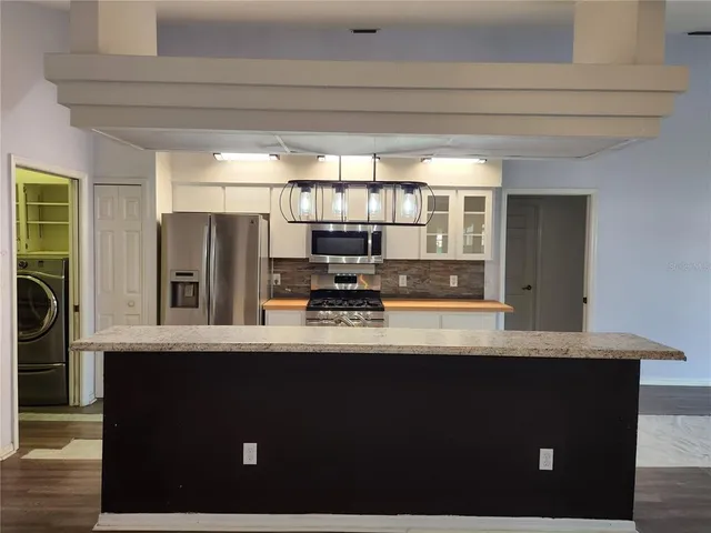 a kitchen with stainless steel appliances a sink stove and refrigerator