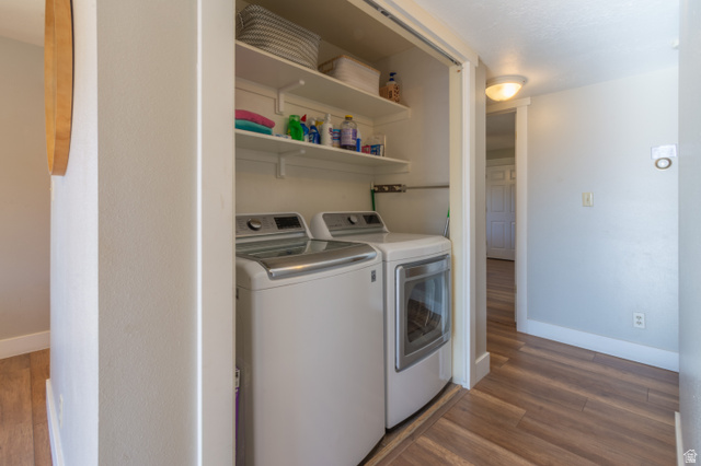 860 South Village Road, Unit Y8 St. George, UT 84770 - Photo 5 of 29 Laundry area with dark wood-type flooring and independent washer and dryer