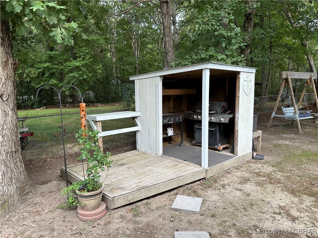 7809 Ark Road Gloucester, VA 23061 - Photo 23 of 32 Wooden deck featuring area for grilling and an outbuilding