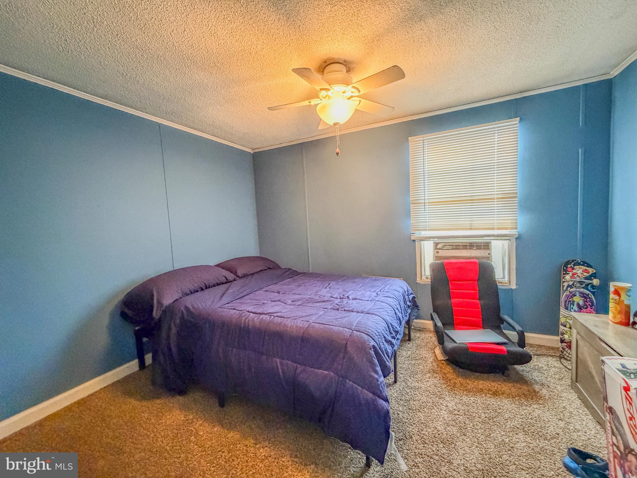 29 West Reybold Drive, Unit 29 Middletown, DE 19709 - Photo 6 of 11 a bedroom with a bed and a chandelier