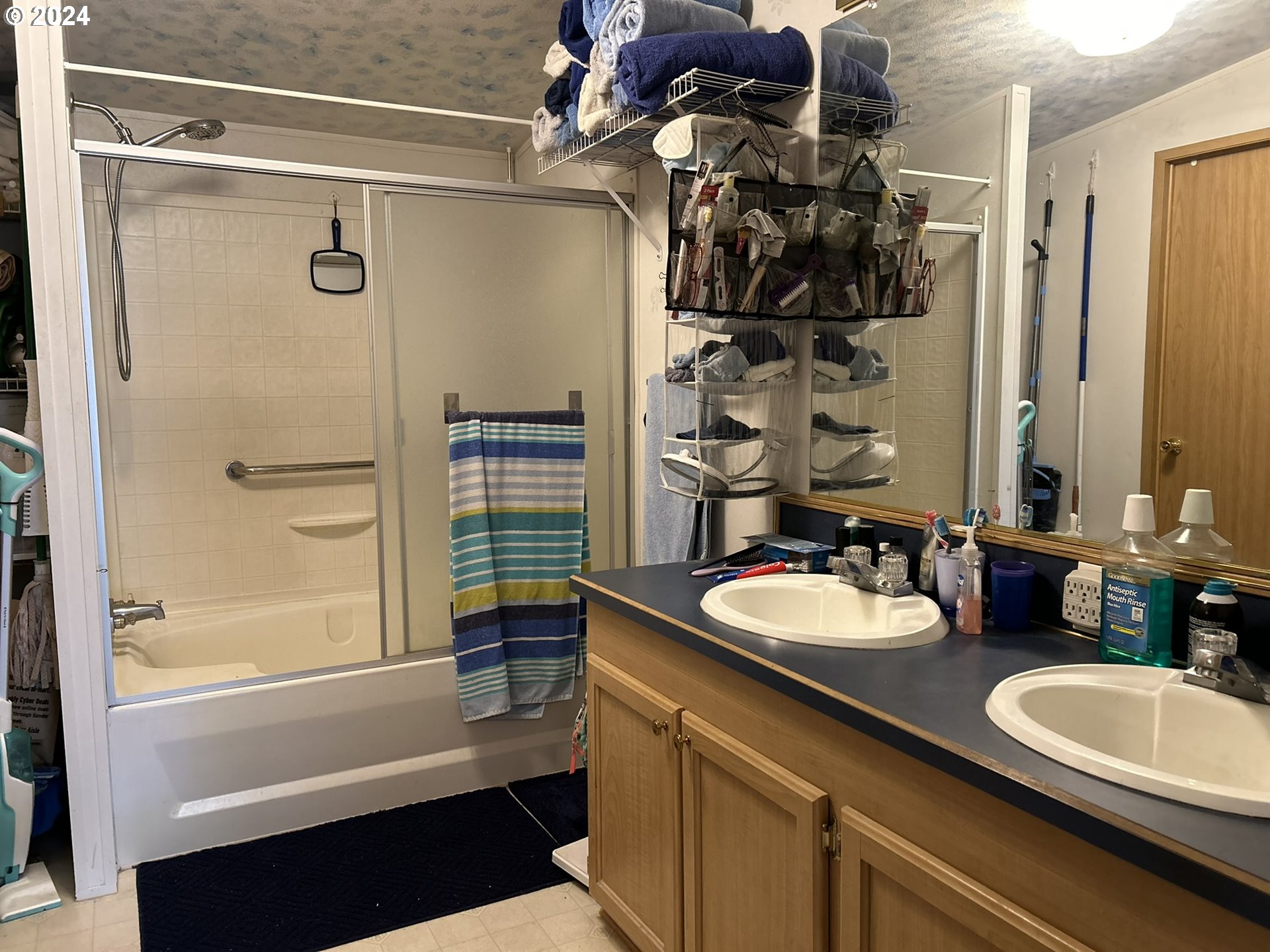 5391 Buckskin Bob Road Florence, OR 97439 - Photo 11 of 42 a bathroom with a double vanity sink toilet mirror and shower