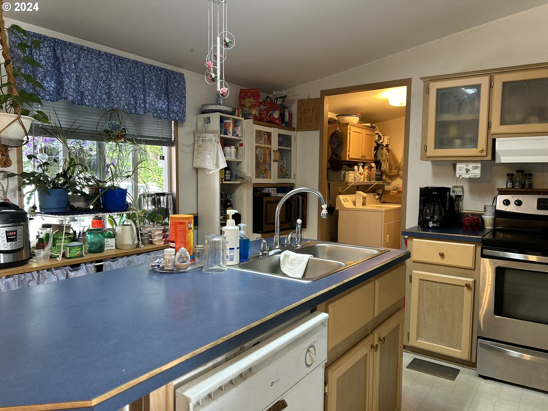 5391 Buckskin Bob Road Florence, OR 97439 - Photo 20 of 42 a kitchen with stainless steel appliances a sink a counter top space cabinets and a window