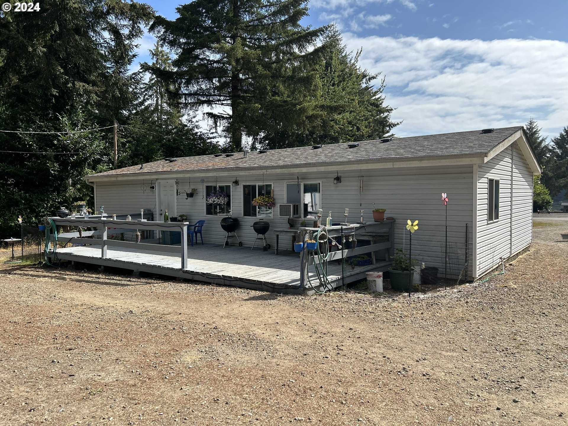 5391 Buckskin Bob Road Florence, OR 97439 - Photo 23 of 42 a view of a house with a yard and sitting area