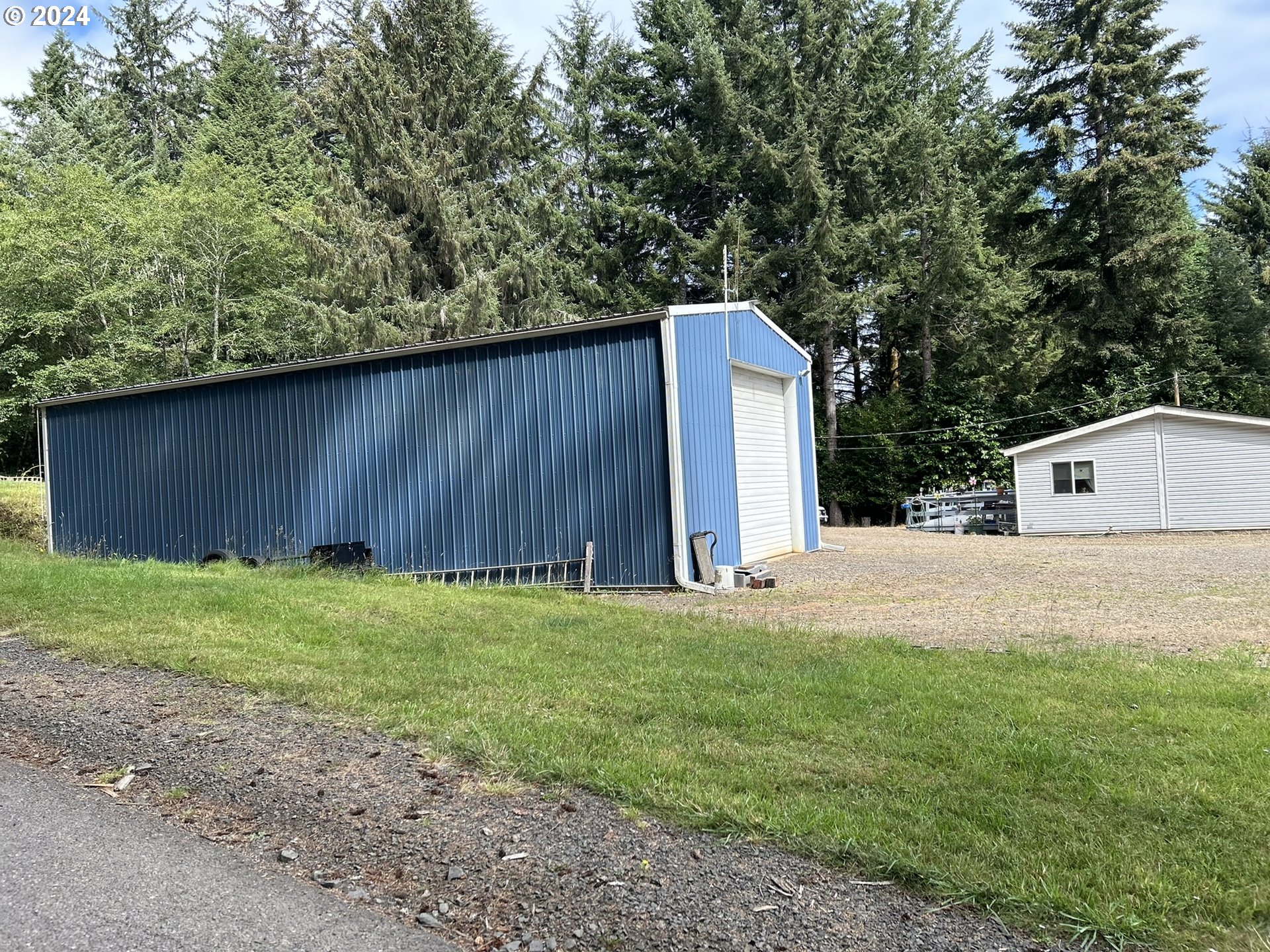 5391 Buckskin Bob Road Florence, OR 97439 - Photo 26 of 42 a backyard of a house with lots of green space