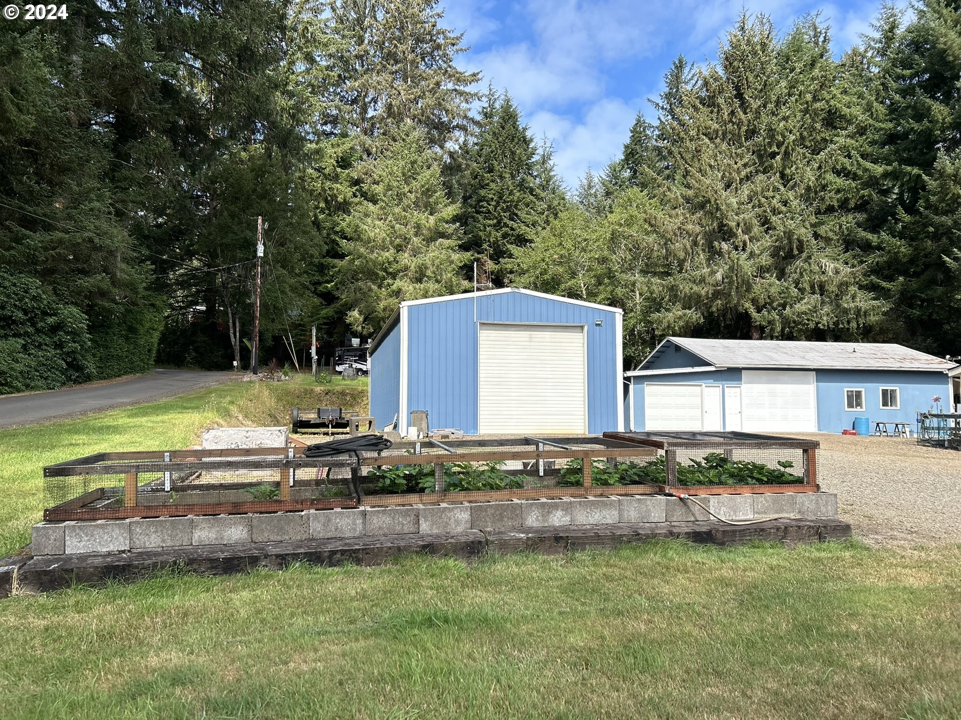 5391 Buckskin Bob Road Florence, OR 97439 - Photo 28 of 42 a view of a house with a yard and sitting area